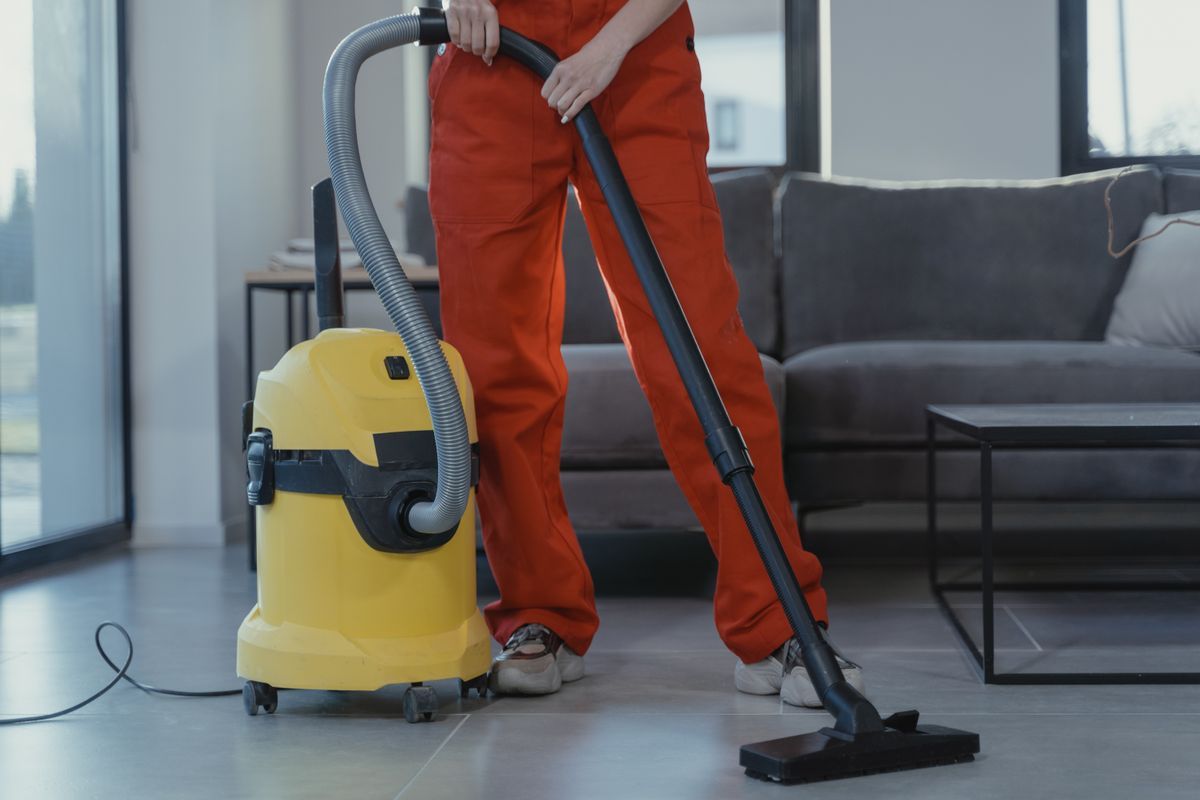 Professional vacuuming a floor