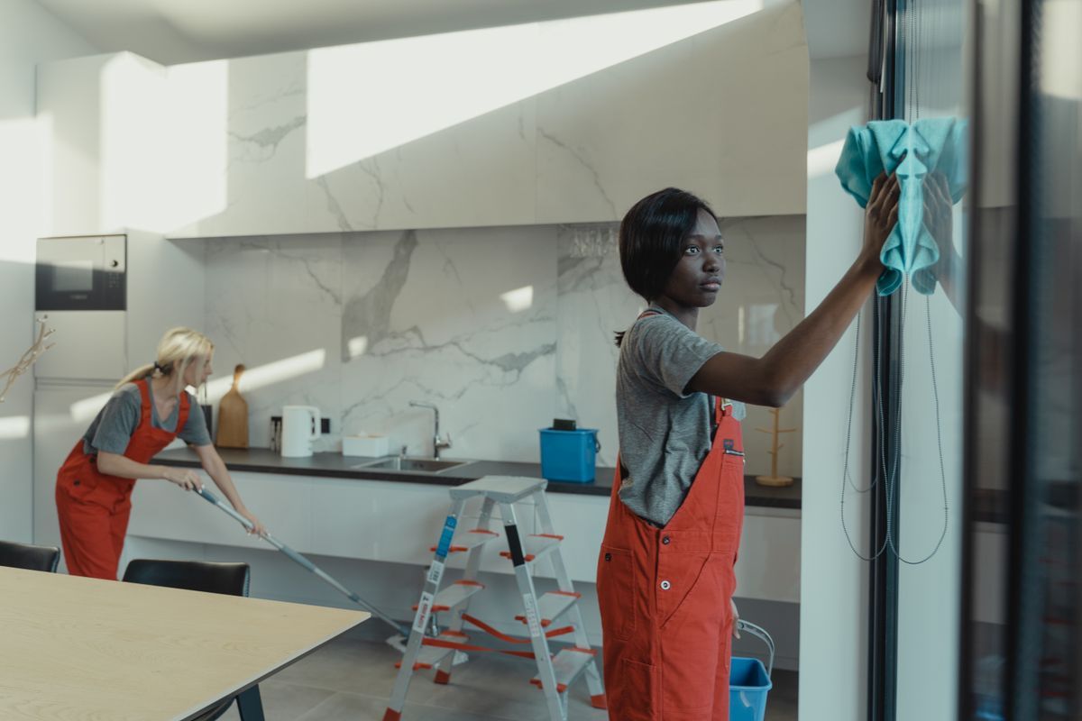 Janitor wiping glass partition